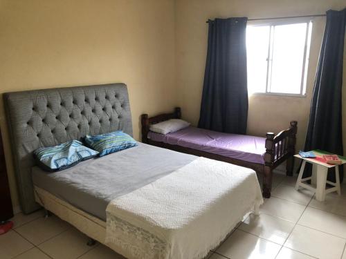 a bedroom with two beds and a window at Casa de Praia - Carneiros, Tamandare, Pernambuco in Tamandaré