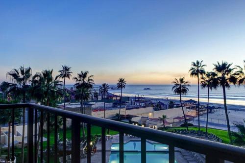 a view of a beach with palm trees and the ocean at Oceana Casa Del Mar in Rosarito