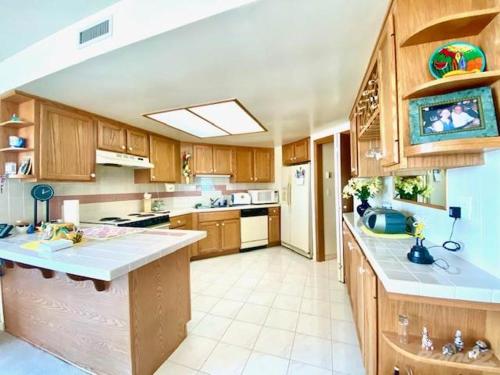 a large kitchen with wooden cabinets and a counter top at Oceana Casa Del Mar in Rosarito