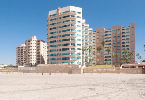 a view of a beach with buildings in the background at Oceana Casa Del Mar in Rosarito
