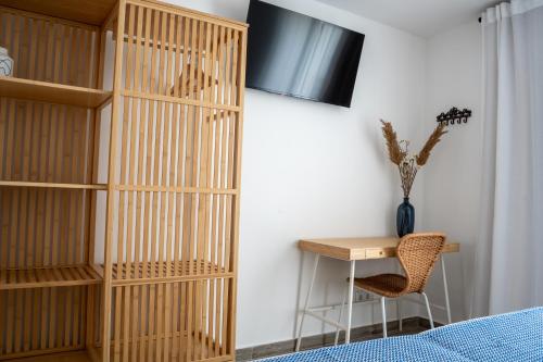 a bedroom with a book shelf and a desk at Tavira Nomad Guesthouse in Tavira