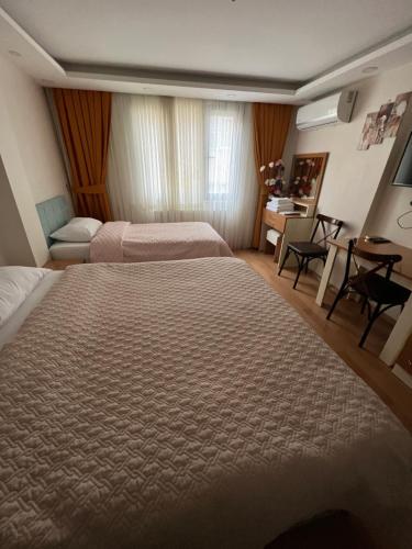 a bedroom with two beds and a table and a desk at Hagia sophia studios in Istanbul