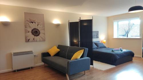 a living room with a couch and a bed at Modern 1-Bed Flat in Wigan in Wigan