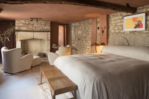 a bedroom with a large bed and a fireplace at BULL Burford in Burford