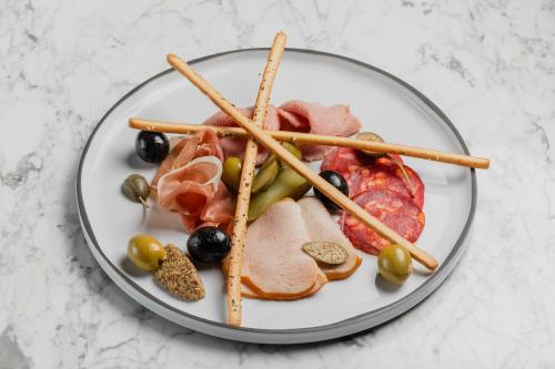 a plate of food with meat and vegetables and chopsticks at The Ritz-Carlton, Baku in Baku