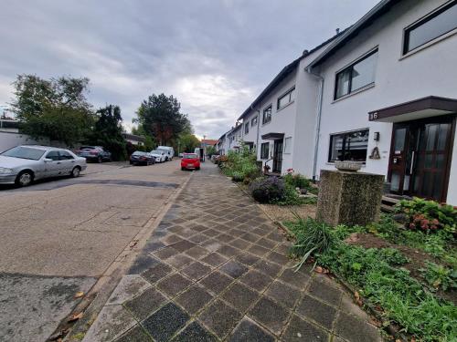 a cobblestone street next to a white building at Cheerful Roof Flat in a Private German Style House in Mannheim