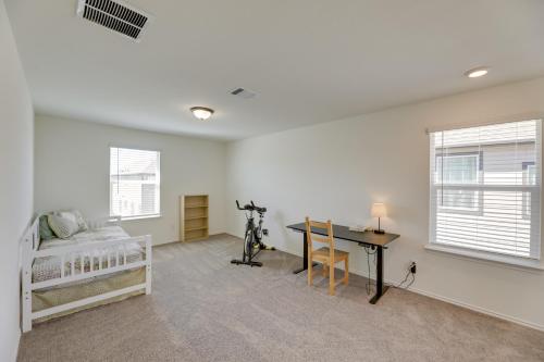 a bedroom with a bed and a desk in a room at Manor Vacation Rental with Yard 17 Mi to Austin! in Manor