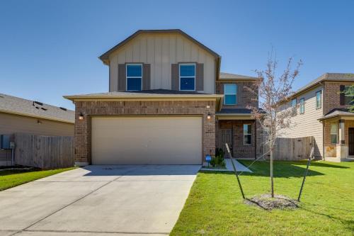 a house with a garage in a yard at Manor Vacation Rental with Yard 17 Mi to Austin! in Manor