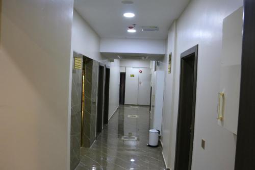 a hallway with a hallway leading to a room at Marina Town in Sohar