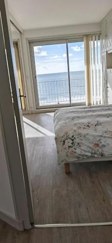 une chambre avec un lit avec vue sur l'océan dans l'établissement Le Splendid, à La Baule