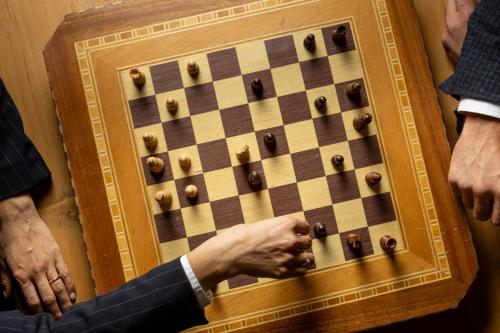 a man is playing chess on a chessboard at Camana Veglia in Livigno