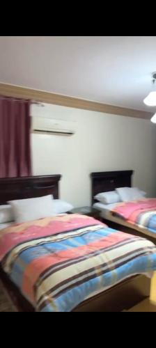 a bedroom with two beds at مدينه نصر القاهره in Cairo