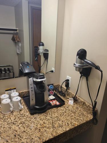 a coffee maker on a counter in a hotel room at BCMInns - Lloydminster in Lloydminster