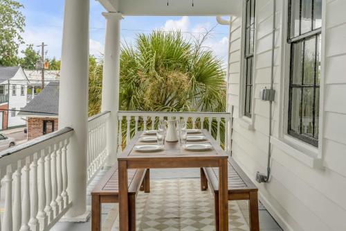 a wooden table on the balcony of a house at The Palmetto House B- Walk To King Street in Charleston