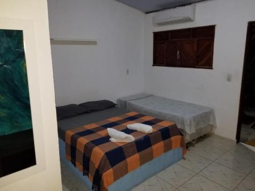 Tempat tidur dalam kamar di Camaleão no Sossego Pipa