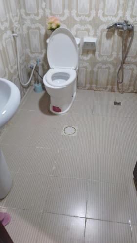 a bathroom with a toilet and a sink at jason apartment in Abu Dhabi