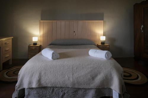 a bedroom with a large bed with two towels on it at CASA RURAL PALACIO CONDE DE ALDANA con piscina entre encinares y dehesas in Terradillos
