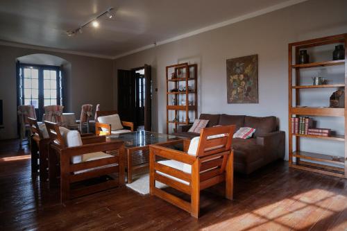 a living room with a table and chairs and a couch at CASA RURAL PALACIO CONDE DE ALDANA con piscina entre encinares y dehesas in Terradillos
