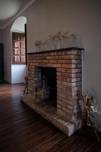 a brick fireplace in the middle of a room at CASA RURAL PALACIO CONDE DE ALDANA con piscina entre encinares y dehesas in Terradillos