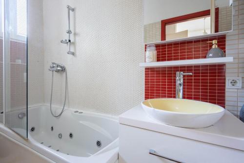 a bathroom with a sink and a tub and a shower at Apartment Ana By Blue Apartments in Zagreb