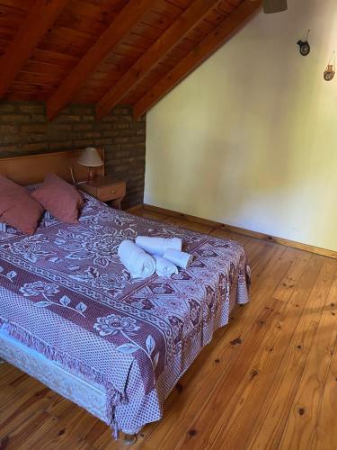 a bedroom with a bed with two pillows on it at Cabañas flotter in Villa Ventana