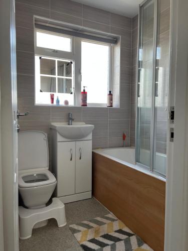 a bathroom with a toilet and a sink and a tub at 31 in Willerby