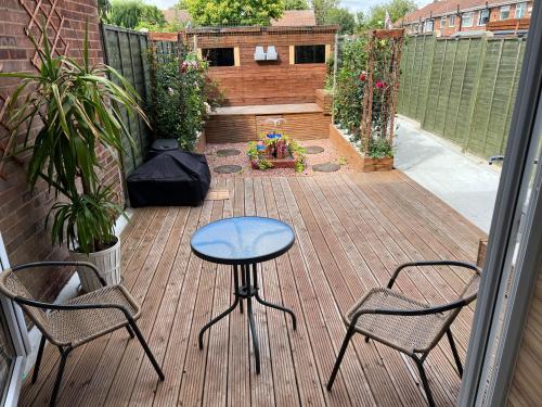 a patio with two chairs and a table on a deck at 31 in Willerby