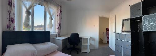 a bedroom with a bed and a desk and a window at 31 in Willerby