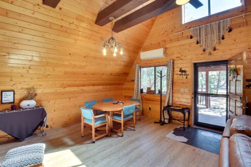 a dining room in a log cabin with a table and chairs at Decks and Fire Pit Rustic-Modern Overgaard Cabin! in Overgaard