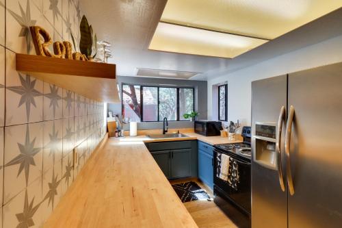 a kitchen with a sink and a refrigerator at Decks and Fire Pit Rustic-Modern Overgaard Cabin! in Overgaard