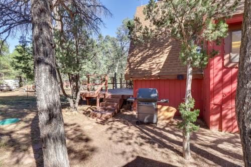 a backyard with a barbecue and a red shed at Decks and Fire Pit Rustic-Modern Overgaard Cabin! in Overgaard