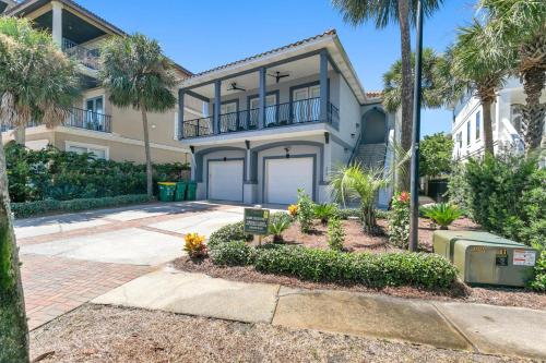 a house with palm trees in front of it at Our Destiny in Dunes of Destin - Is a 4BR with Private Pool and close Beach Access in Destin