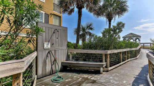 a wooden gate with a bench on a boardwalk at Our Destiny in Dunes of Destin - Is a 4BR with Private Pool and close Beach Access in Destin