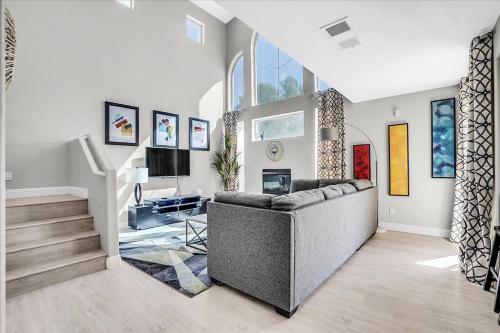 a living room with a couch and a tv at Gorgeous and Spacious home! in Las Vegas