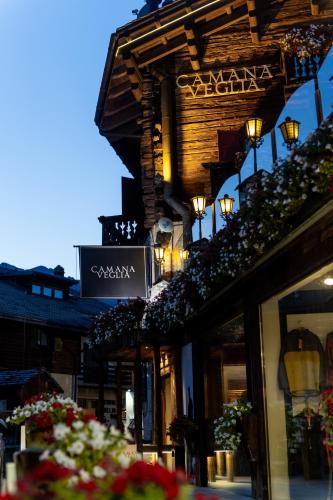 a building with a sign on the side of it at Camana Veglia in Livigno