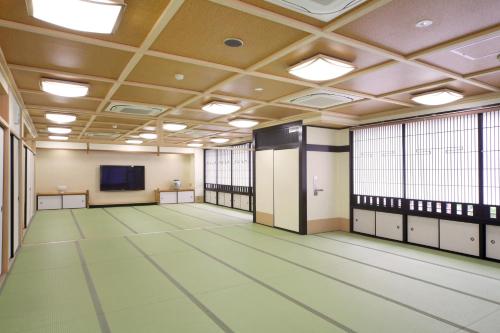 an empty room with a large room with windows at Hotel Chatelet Inn Kyoto in Kyoto