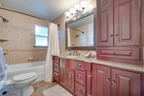 een badkamer met een rode kast, een toilet en een wastafel bij Charming Getaway, Walk to Windsor Lake and Downtown! in Windsor