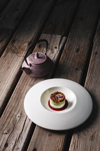 a white plate with a piece of cake on a table at Camana Veglia in Livigno