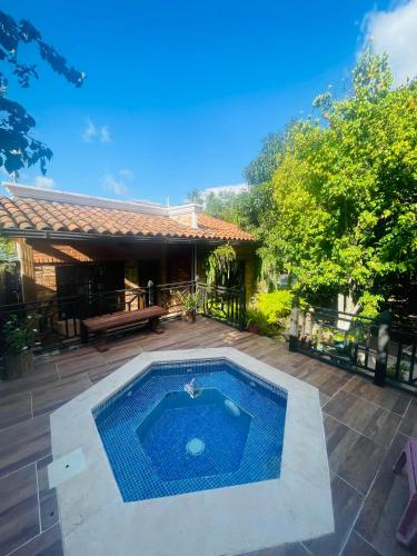 a swimming pool in the middle of a yard at Cabañas Marroquin 2 in Ostumán