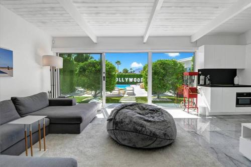 a living room with a couch and a table at Palm Springs Luxury Home With Pool and Next to Downtown & Airport in Palm Springs