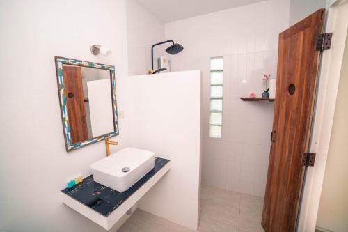 a bathroom with a sink and a mirror at Ocean Pearl Phangan in Baan Tai