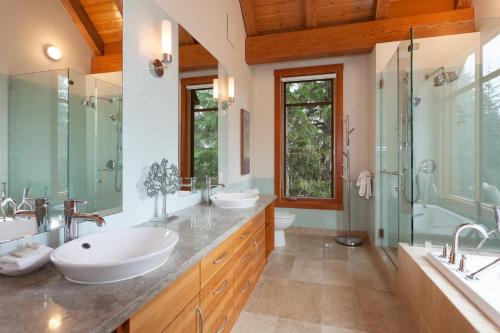 y baño con 2 lavabos y ducha. en Kadenwood 2939 - Luxury Chalet with Hot Tub, Steam Room, Views - Whistler Platinum en Whistler