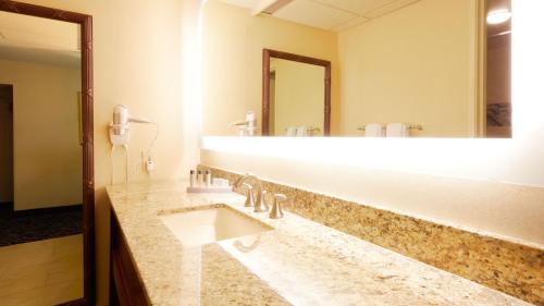 a bathroom with a sink and a large mirror at Eldorado Reno, A Caesars Destination in Reno