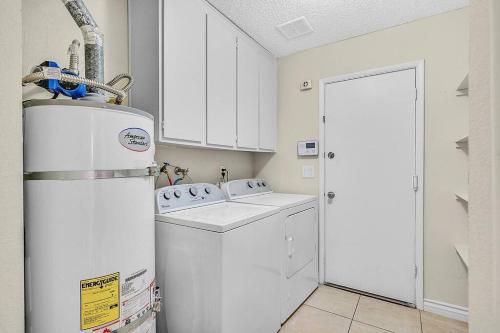 a white laundry room with a washer and dryer at 4BR Family Home, Private Pool & BBQ, Near Strip in Las Vegas