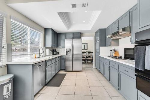 a kitchen with stainless steel appliances and a table at 4BR Family Home, Private Pool & BBQ, Near Strip in Las Vegas