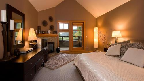 ein Schlafzimmer mit einem Bett und eine Kommode mit einem Spiegel in der Unterkunft Goldenwood 8336 - Large Townhouse, Golf Course Views, Hot Tub, Patio - Whistler Platinum in Whistler
