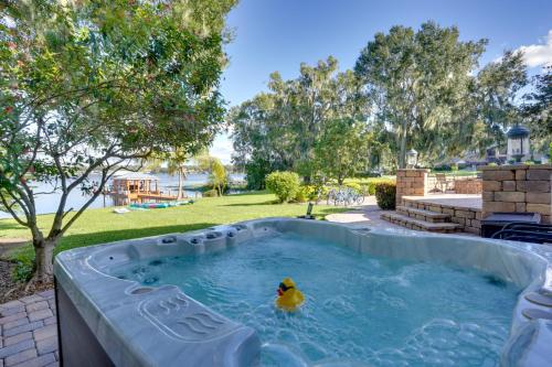 a rubber duck in a pool in a backyard at Lakefront Winter Haven Retreat Hot Tub and Patio! in Winter Haven