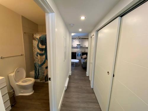 a hallway leading to a bathroom with a toilet at Lovely 1 Bedroom Condo Free Parking And Balcony in Edmonton