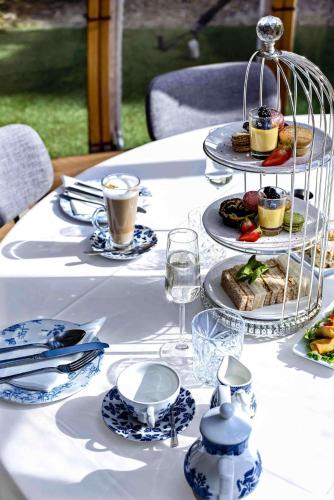 a table with plates of food and drinks on it at Doubletree By Hilton London Kensington in London