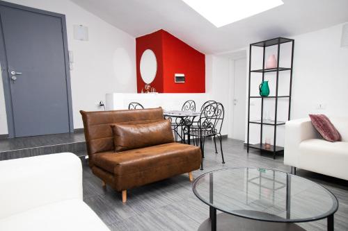 a living room with a couch and a table at Hosting Dreams Attics - Duomo in Milan